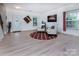 Inviting living area featuring two comfortable armchairs, a decorative rug, and ample natural light from the windows at 6914 Evanton Loch Rd, Charlotte, NC 28278