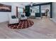 Bright and airy living area with two armchairs, a round patterned rug, and large windows at 6914 Evanton Loch Rd, Charlotte, NC 28278