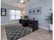 Stylish office with hardwood floors, a modern desk, a framed diploma, and a large window for natural light at 6914 Evanton Loch Rd, Charlotte, NC 28278