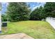 Spacious backyard featuring lush green grass, mature trees, and privacy fencing, ideal for outdoor enjoyment at 6922 Cascade Dream Ct, Huntersville, NC 28078