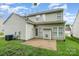 Two-story home with a backyard including grass, a patio, and AC unit, perfect for outdoor activities at 6922 Cascade Dream Ct, Huntersville, NC 28078