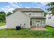 Two-story home with a backyard including grass, a patio, and AC unit, perfect for outdoor activities at 6922 Cascade Dream Ct, Huntersville, NC 28078
