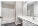 Bathroom with white vanity, mirror, and bathtub/shower combo, offering functionality and classic design at 6922 Cascade Dream Ct, Huntersville, NC 28078