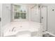 Bathroom with a large soaking tub and glass shower at 6922 Cascade Dream Ct, Huntersville, NC 28078