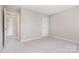Comfortable bedroom with neutral walls, carpeting, and a closet door, offering a serene atmosphere at 6922 Cascade Dream Ct, Huntersville, NC 28078