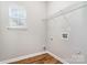 Functional laundry room with hardwood flooring and plenty of shelving at 6922 Cascade Dream Ct, Huntersville, NC 28078