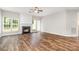 Open-concept living room with hardwood floors, fireplace, and lots of natural light at 6922 Cascade Dream Ct, Huntersville, NC 28078