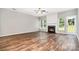 Spacious living room featuring a fireplace, wood floors, and plenty of natural light at 6922 Cascade Dream Ct, Huntersville, NC 28078