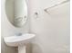 Neat powder room featuring a pedestal sink and modern fixtures at 6922 Cascade Dream Ct, Huntersville, NC 28078