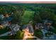Stunning aerial view of a home near the golf course at sunset, surrounded by lush green trees at 7412 Sahalee Dr, Denver, NC 28037