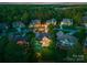A beautiful twilight aerial view showcases the home's setting among lush trees and well-manicured lawns at 7412 Sahalee Dr, Denver, NC 28037