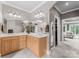 Bathroom featuring double sinks, large mirrors, and walk-in closet access at 7412 Sahalee Dr, Denver, NC 28037