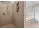 Bathroom featuring a tiled shower, built in shelving and a soaking tub at 7412 Sahalee Dr, Denver, NC 28037