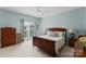 Bedroom with light blue walls, carpeted floor, a ceiling fan and window with curtains at 7412 Sahalee Dr, Denver, NC 28037