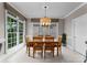 Dining room featuring a large window with natural light and modern lighting fixture at 7412 Sahalee Dr, Denver, NC 28037