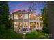Stately brick home with a spacious patio, fire pit, and lush landscaping, perfect for outdoor entertaining at 7412 Sahalee Dr, Denver, NC 28037