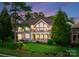 Beautiful brick home with lush landscaping, a covered patio, and a manicured lawn at 7412 Sahalee Dr, Denver, NC 28037