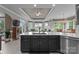 Kitchen with dark cabinets and white countertops that overlooks living and dining area with lots of natural light at 7412 Sahalee Dr, Denver, NC 28037