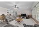Comfortable living area featuring a plush sofa, built-in shelving, and large windows for natural light at 7412 Sahalee Dr, Denver, NC 28037