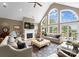 Inviting living room with a fireplace, vaulted ceilings, large windows, and comfortable seating at 7412 Sahalee Dr, Denver, NC 28037
