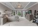 Large main bedroom with a sitting area and tray ceiling, featuring neutral colors at 7412 Sahalee Dr, Denver, NC 28037