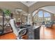 Spacious office with large arched windows, hardwood floors, and open access to the living room at 7412 Sahalee Dr, Denver, NC 28037
