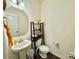 Neat half bathroom featuring a pedestal sink, modern fixtures, and decorative shelves at 750 Fraternity Row, Kannapolis, NC 28081