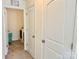 Hallway view of laundry room featuring tile floors and modern appliances at 750 Fraternity Row, Kannapolis, NC 28081
