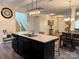 Kitchen island and dining area with black cabinets and an open floor plan at 750 Fraternity Row, Kannapolis, NC 28081