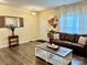 Inviting living room featuring hardwood floors, a comfortable leather sofa, and stylish wall decorations at 750 Fraternity Row, Kannapolis, NC 28081