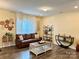 Cozy living room featuring a leather sofa, decorative shelving, and ample natural light at 750 Fraternity Row, Kannapolis, NC 28081