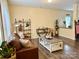 Inviting living room with hardwood floors, a comfortable leather sofa, and stylish decorative accents at 750 Fraternity Row, Kannapolis, NC 28081