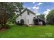 Exterior view of a home featuring a deck, lush greenery, and a well-manicured lawn at 8008 Alba Ct, Charlotte, NC 28269