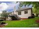 Exterior view of a home showcasing a deck, patio, and well-maintained backyard at 8008 Alba Ct, Charlotte, NC 28269