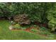 Aerial view of the backyard showcases a landscaped garden, mature trees, and a lush green lawn, perfect for outdoor living at 8008 Alba Ct, Charlotte, NC 28269