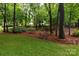Serene backyard with walking path and mature trees offering plenty of shade and privacy at 8008 Alba Ct, Charlotte, NC 28269