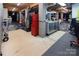 Unfinished basement featuring a workbench, storage area, and concrete flooring at 8008 Alba Ct, Charlotte, NC 28269