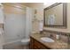 Bathroom showcasing a vanity with granite countertop, tiled backsplash, and a shower-tub combo at 8008 Alba Ct, Charlotte, NC 28269