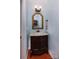 Powder room featuring a dark wood vanity and marble countertop, accentuated by a gold-framed mirror at 8008 Alba Ct, Charlotte, NC 28269