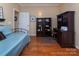 Comfortable bedroom with desk, chair, and dresser, featuring hardwood flooring throughout at 8008 Alba Ct, Charlotte, NC 28269