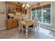 Cozy dining area with a wooden table and chairs is illuminated by natural light at 8008 Alba Ct, Charlotte, NC 28269
