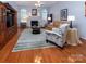 Inviting living room with a fireplace, hardwood floors, and comfortable seating arrangement at 8008 Alba Ct, Charlotte, NC 28269