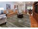 Cozy living room with hardwood floors, comfortable seating, and an open view into the dining area at 8008 Alba Ct, Charlotte, NC 28269