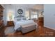 Spacious main bedroom offers a tranquil retreat with hardwood floors, soft lighting and neutral walls at 8008 Alba Ct, Charlotte, NC 28269