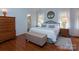 This is an expansive main bedroom showcasing hardwood floors and soft, light-colored walls at 8008 Alba Ct, Charlotte, NC 28269