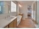 Bright bathroom with wood floors, soaking tub, and double vanity sinks at 8039 Mcconnell Rd, Denver, NC 28037