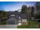 Beautiful craftsman-style home with a modern dark gray color scheme, a spacious driveway, and professionally landscaped yard at 8039 Mcconnell Rd, Denver, NC 28037