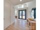 Bright hallway featuring hardwood floors, stylish console table, and an open view to the living area at 8039 Mcconnell Rd, Denver, NC 28037