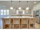 Modern kitchen boasts a large island with seating, pendant lighting, and stainless steel appliances at 8039 Mcconnell Rd, Denver, NC 28037