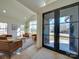 Open-concept space showcasing front entry double doors, modern furniture, and bright natural light at 8039 Mcconnell Rd, Denver, NC 28037